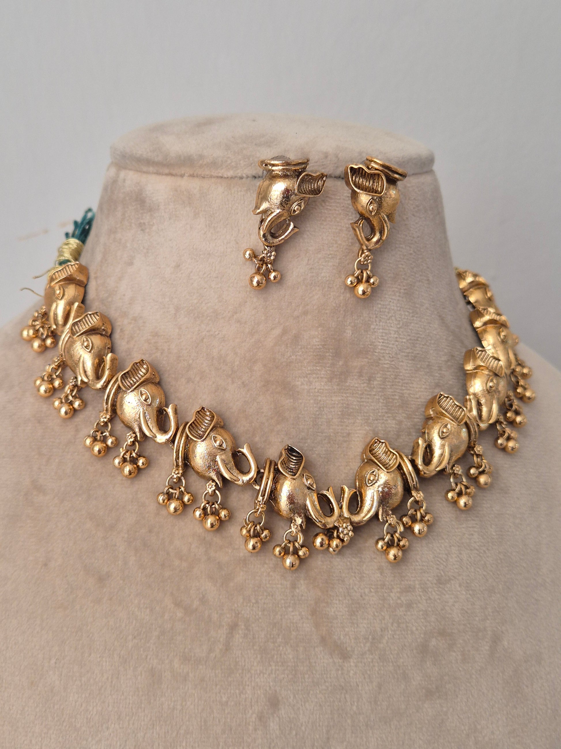 Gold necklace with very detailed designs ten elephants faces connected and hanged golden beads by naitri.in
