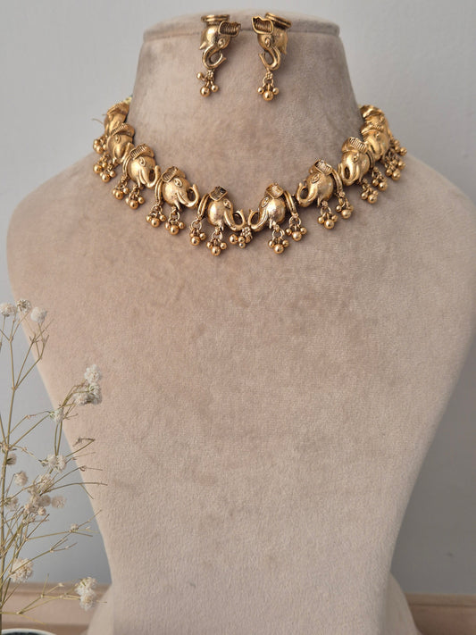 Gold necklace with crafted elephants with elephant face studs statement necklace by naitri.n