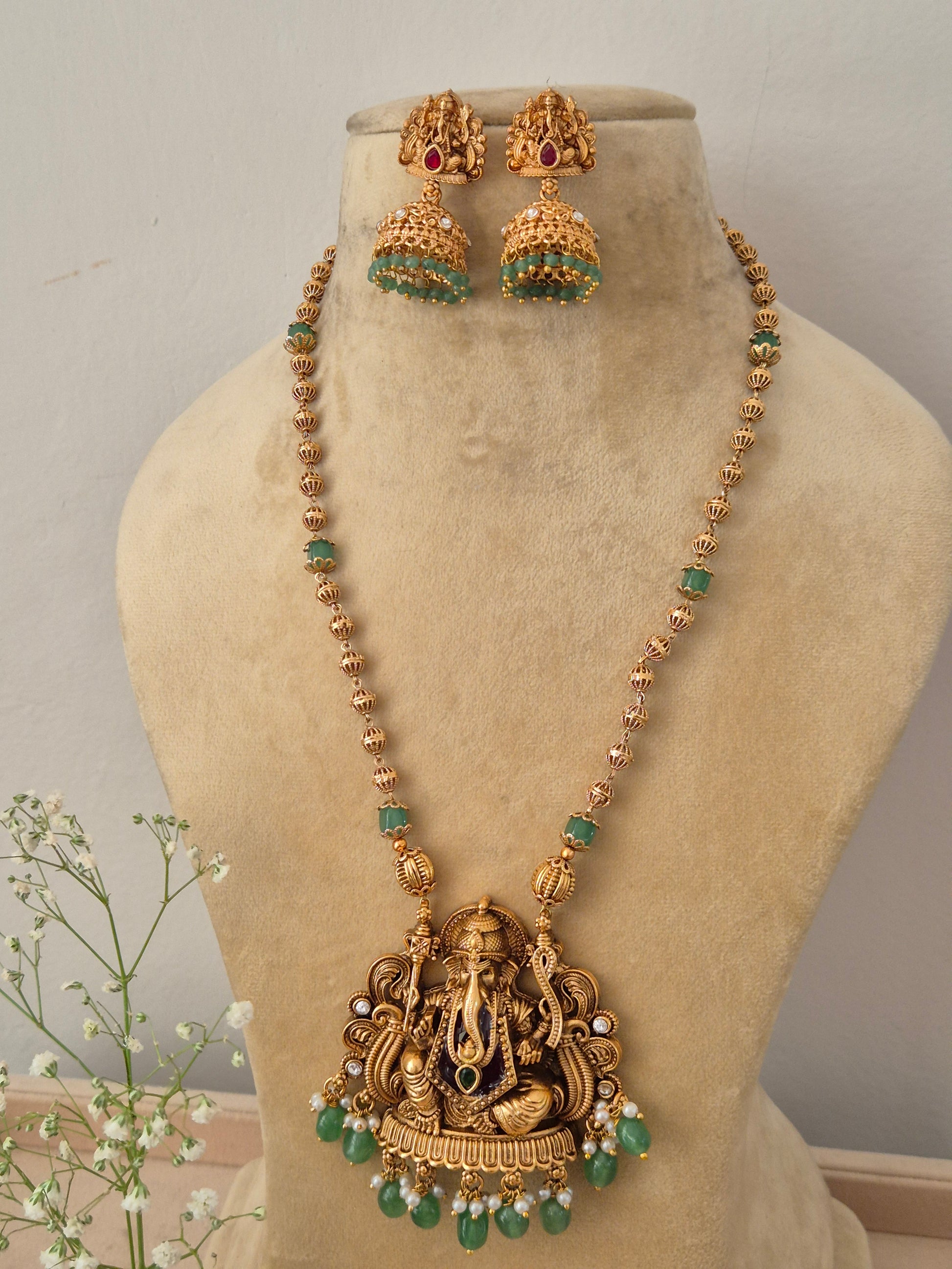 Elegant traditional gold-toned ethnic necklace set featuring detailed religious motif carvings by naitri.in 