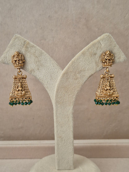Traditional gold-plated Bhumika Jhumka earrings with a Goddess motif and dangling green beads by naitri.in