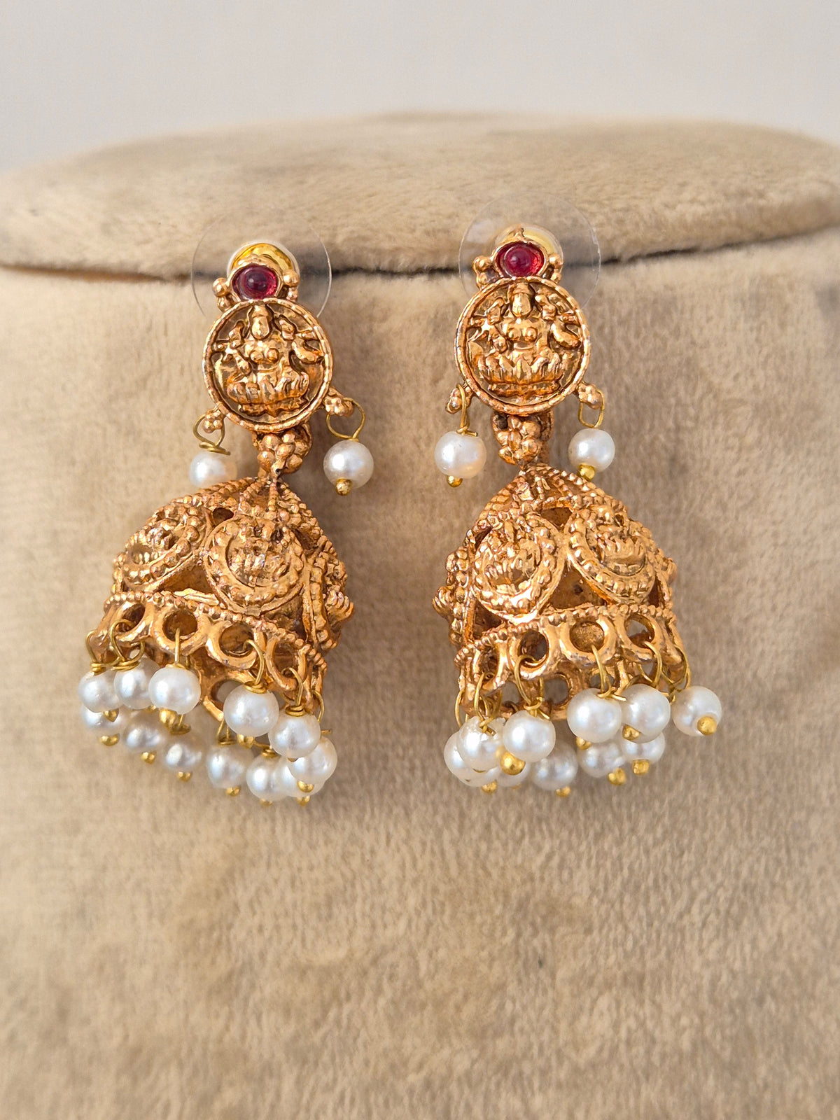 Handcrafted Brass Alloy Statement Necklace with an elaborate central pendant, featuring vibrant gemstone insets and graceful hanging pearls designed for weddings and grand festivities by Naitri.in