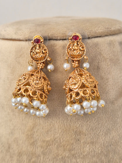 Handcrafted Brass Alloy Statement Necklace with an elaborate central pendant, featuring vibrant gemstone insets and graceful hanging pearls designed for weddings and grand festivities by Naitri.in