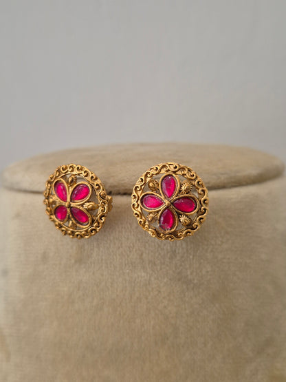Modern Indian imitation earrings with a central pink stone floral motif and two matching round floral earrings by naitri.in