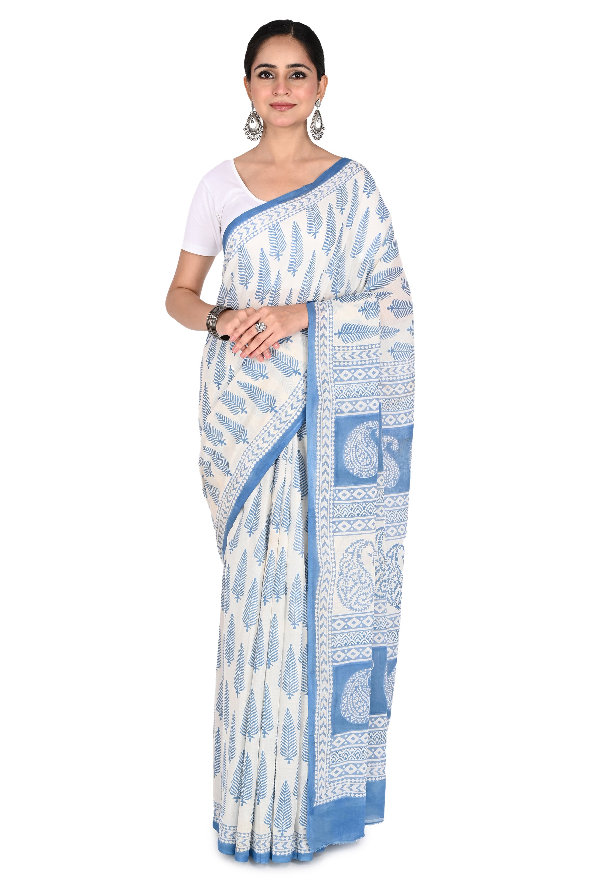 Woman modeling the Brishti Hand Block Printed Cotton Saree, featuring a white base with intricate blue Bagh geometric patterns and a classic drape by naitri.in
