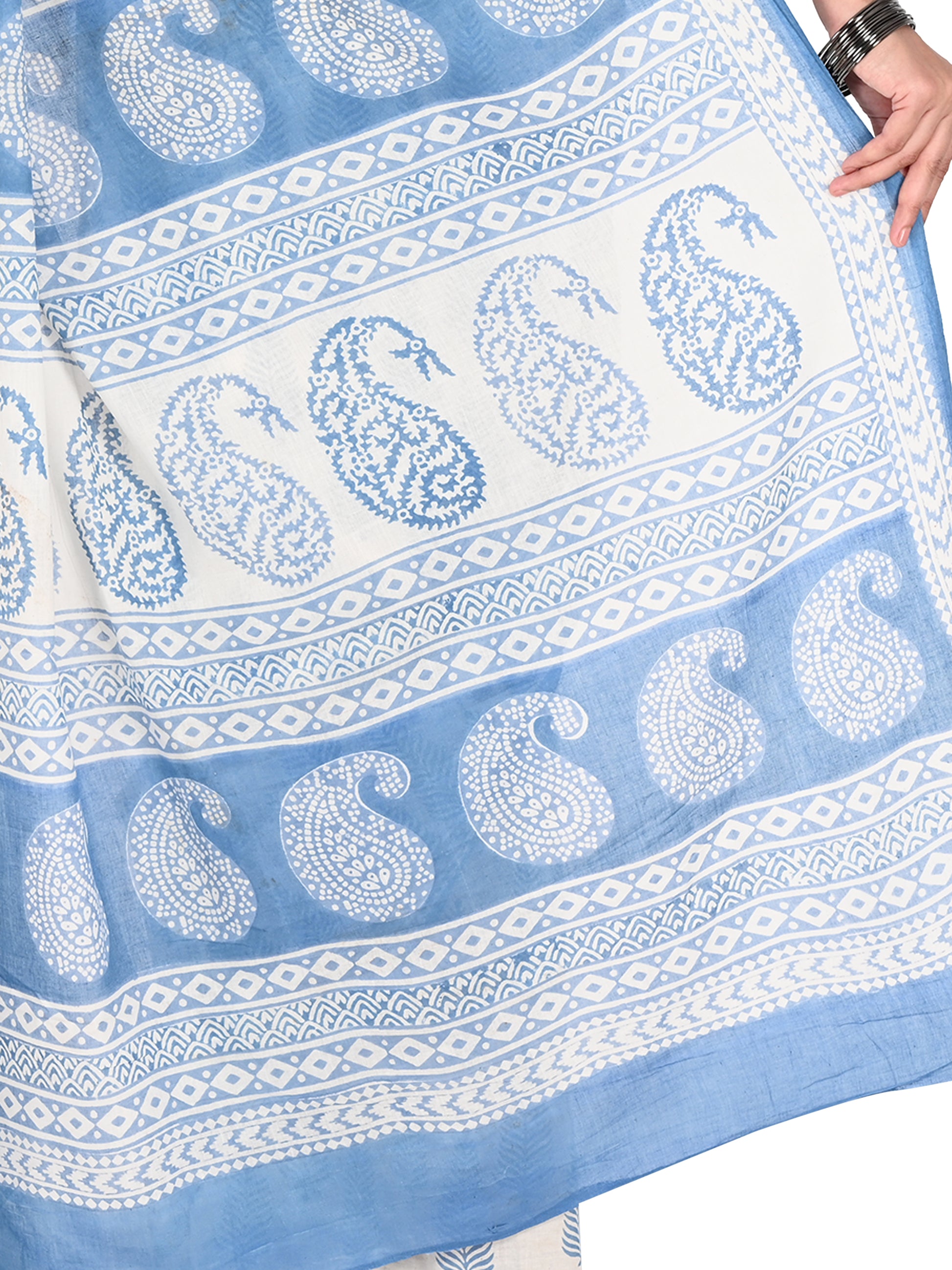 Detailed shot of the blue geometric hand block print texture on high-quality white cotton fabric from the Naitri Saree collection by naitri.in