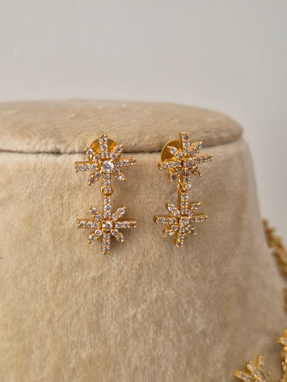 Gold-toned star-motif stud earrings brass alloy with a polished golden finish by naitri.in