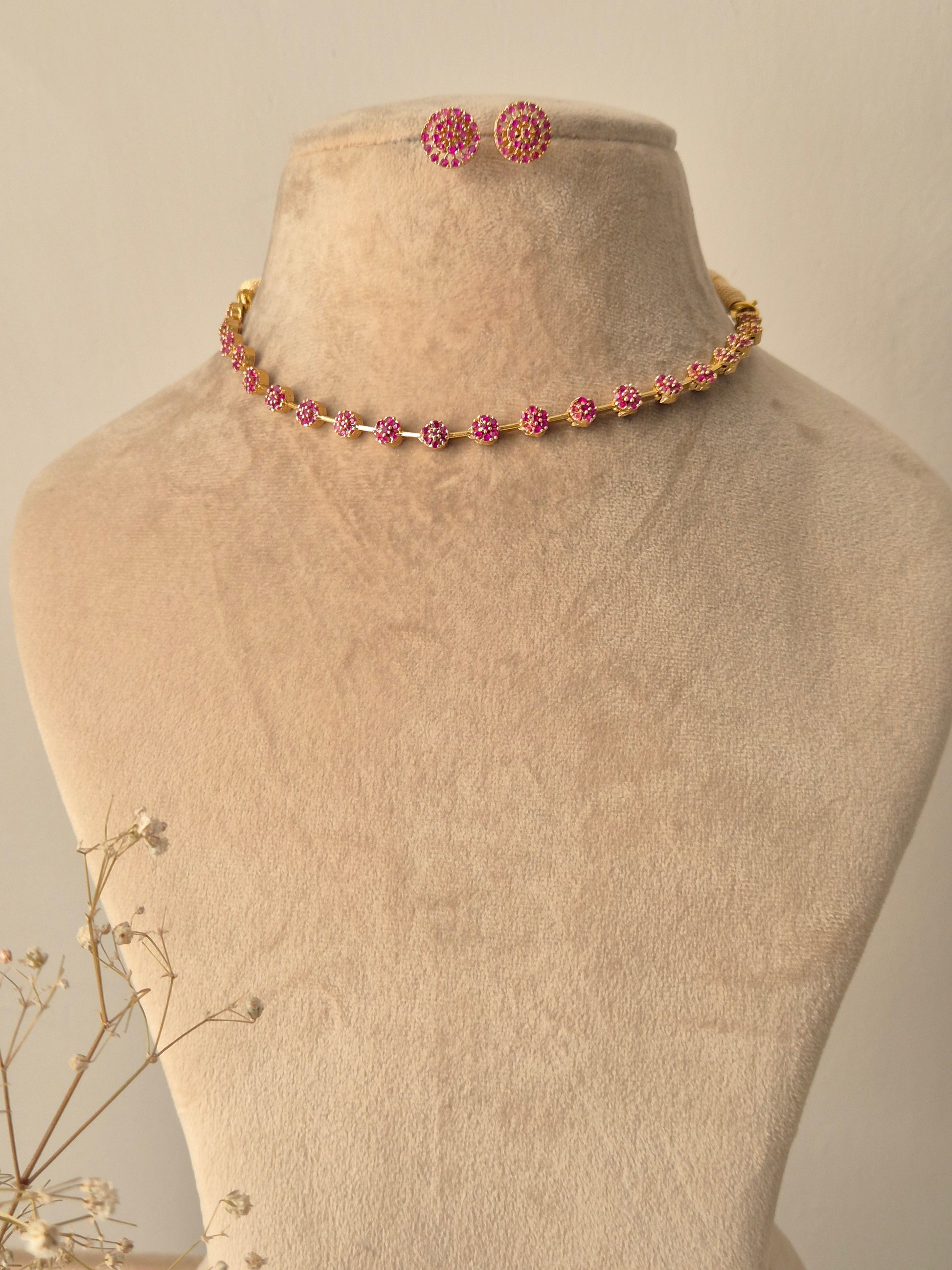 Chameli Necklace Set featuring a minimal gold-plated chain with pink American Diamond accents and matching floral stud earrings by naitri.in