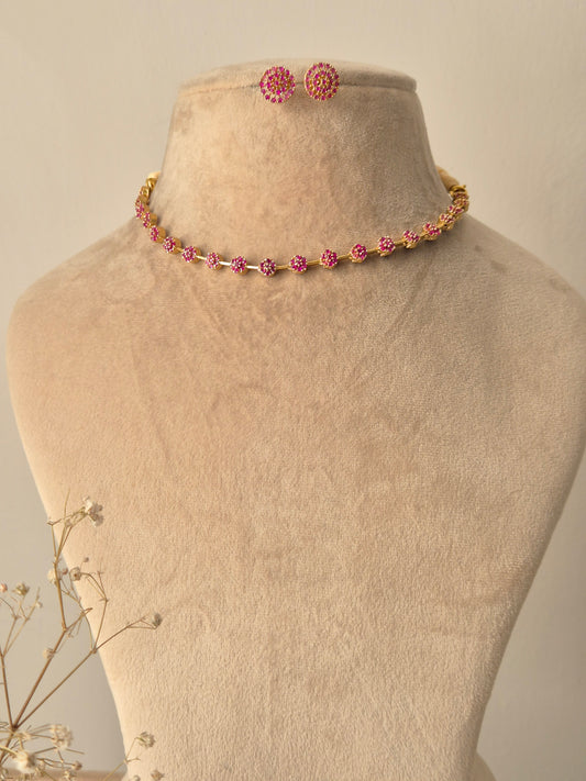 Chameli Necklace Set featuring a minimal gold-plated chain with pink American Diamond accents and matching floral stud earrings by naitri.in