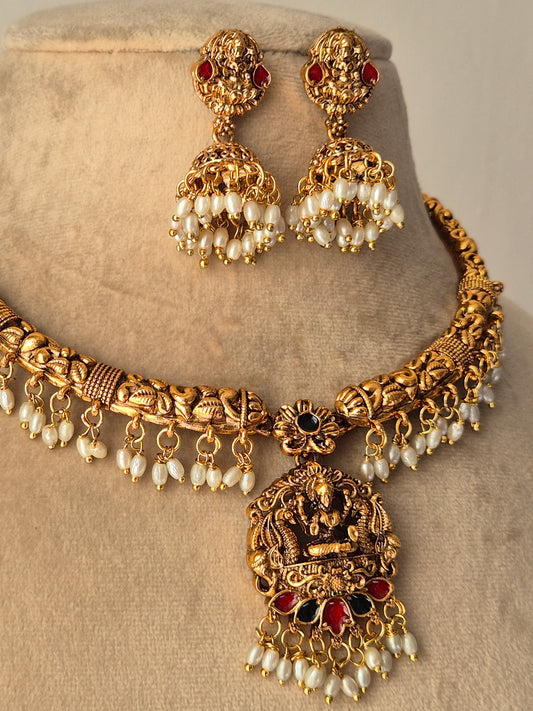 A showstopper piece with white pearls beads dropping down, goddess motif design jhumki  and necklace by naitri.in