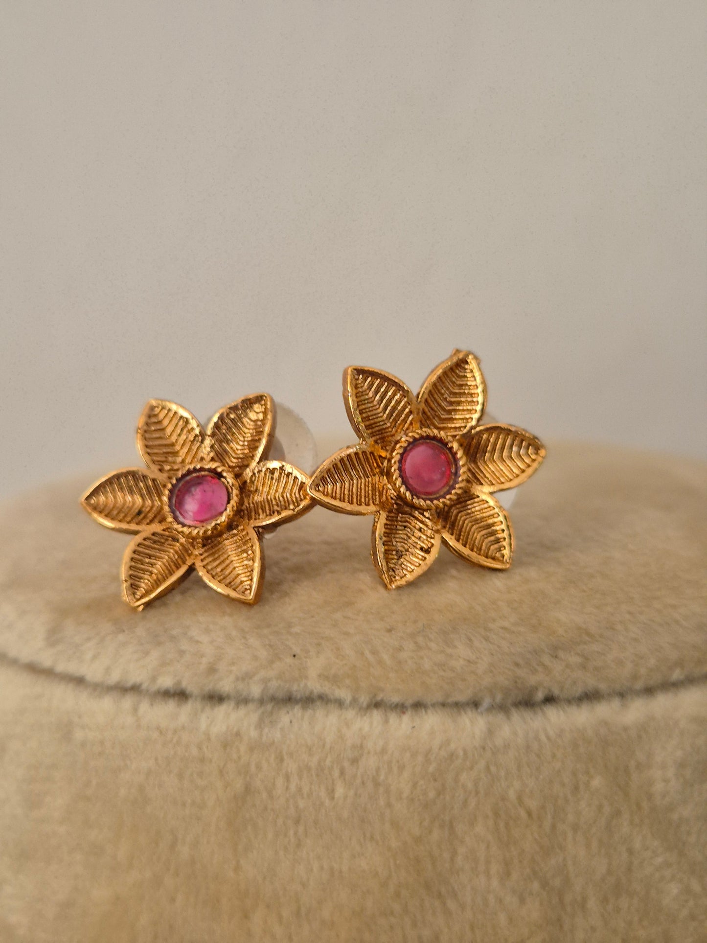 Gold-plated floral earrings with pink-red stones by naitri.in