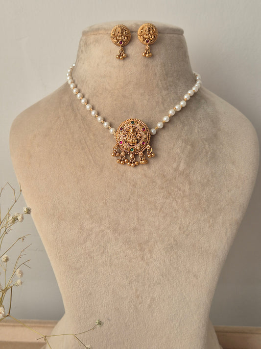 Set of gold jewelry with pearls single chain, central motif representing purity and enlightenment, often used as a throne for the goddess by naitri.in