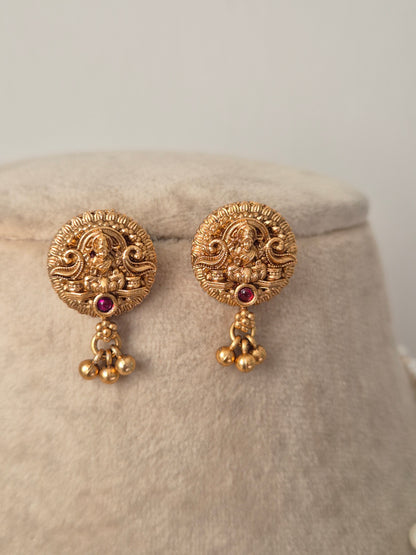 Gold earrings with intricate designs and colorful beads by naitri.in