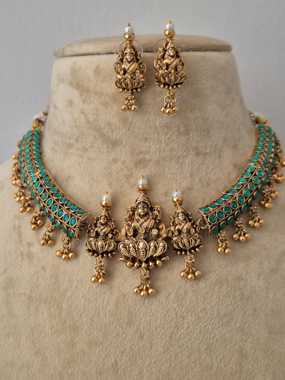 Gold-plated traditional Indian jewelry set featuring a choker necklace, matching earrings, and a headpiece with turquoise blue stone accents and small white pearl details, by naitri.in
