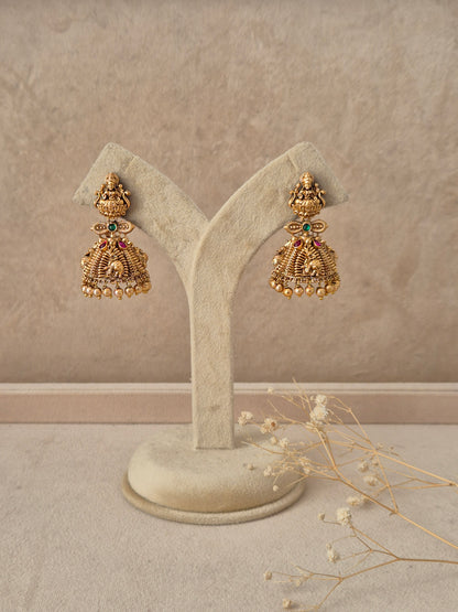 Chirashree handcrafted gold jhumka earrings with intricate temple motifs and stone accents by naitri.in