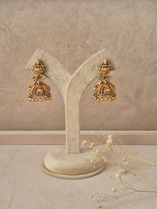 Chirashree handcrafted gold jhumka earrings with intricate temple motifs and stone accents by naitri.in