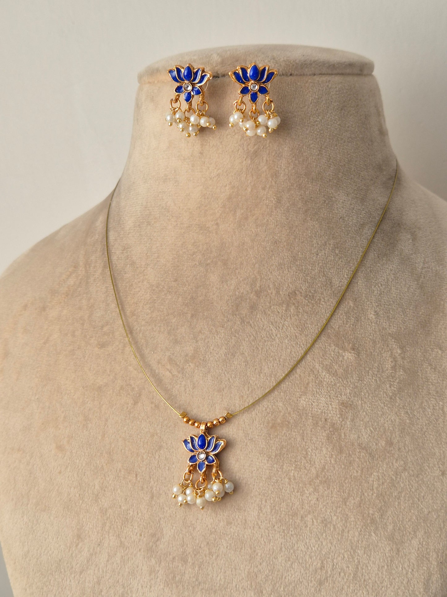 Gold plated necklace and earrings with blue lotus, golden beads and small stone in middle, some small pearls, Timeless, High-quality by naitri.in