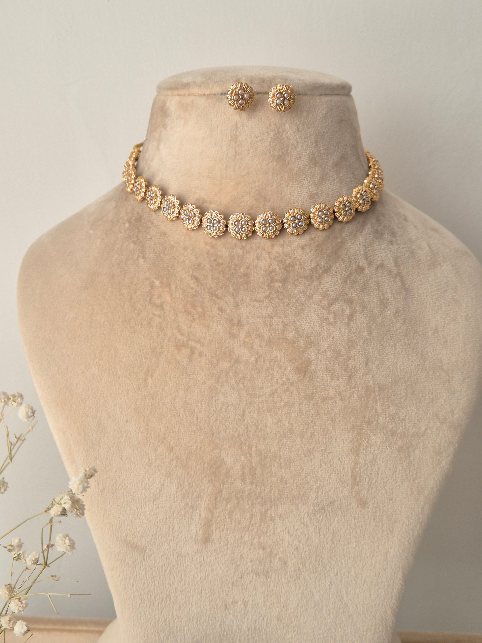 Golden necklace with small flower design by naitri