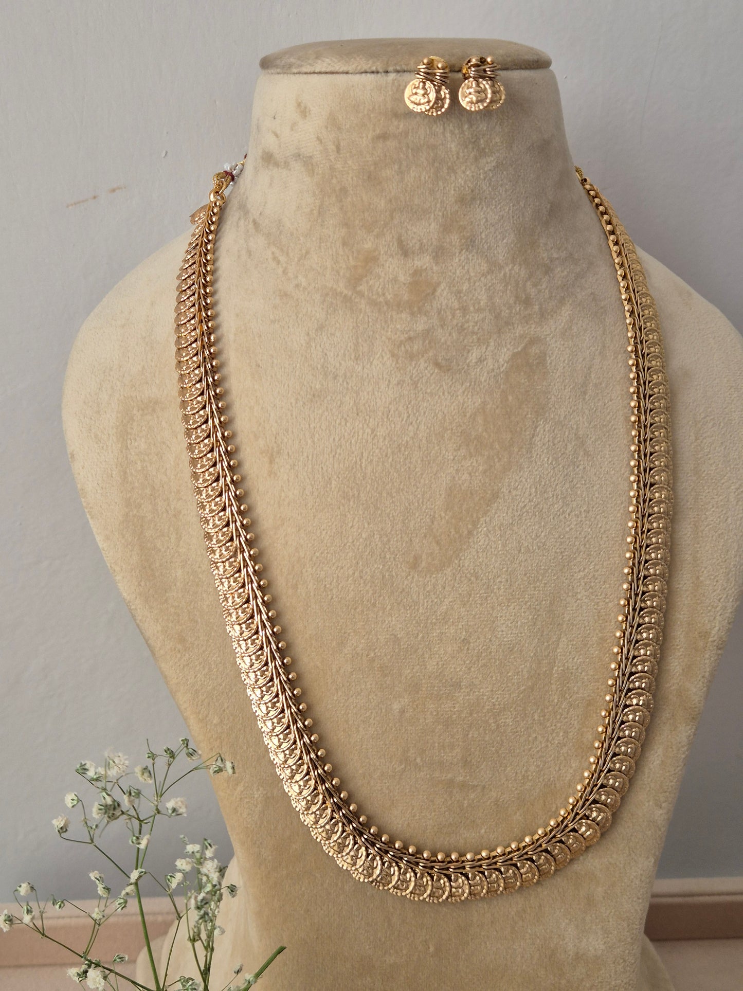 Elaborate gold-toned collar-to-chest length opera necklace featuring textured metallic bead motifs and woven patterns, shown with coordinating round earrings, Handcrafted antique gold statement jewelry set showcasing a multi-textured ethnic design, ideal for festive, traditional, or bridal wear by naitri.in