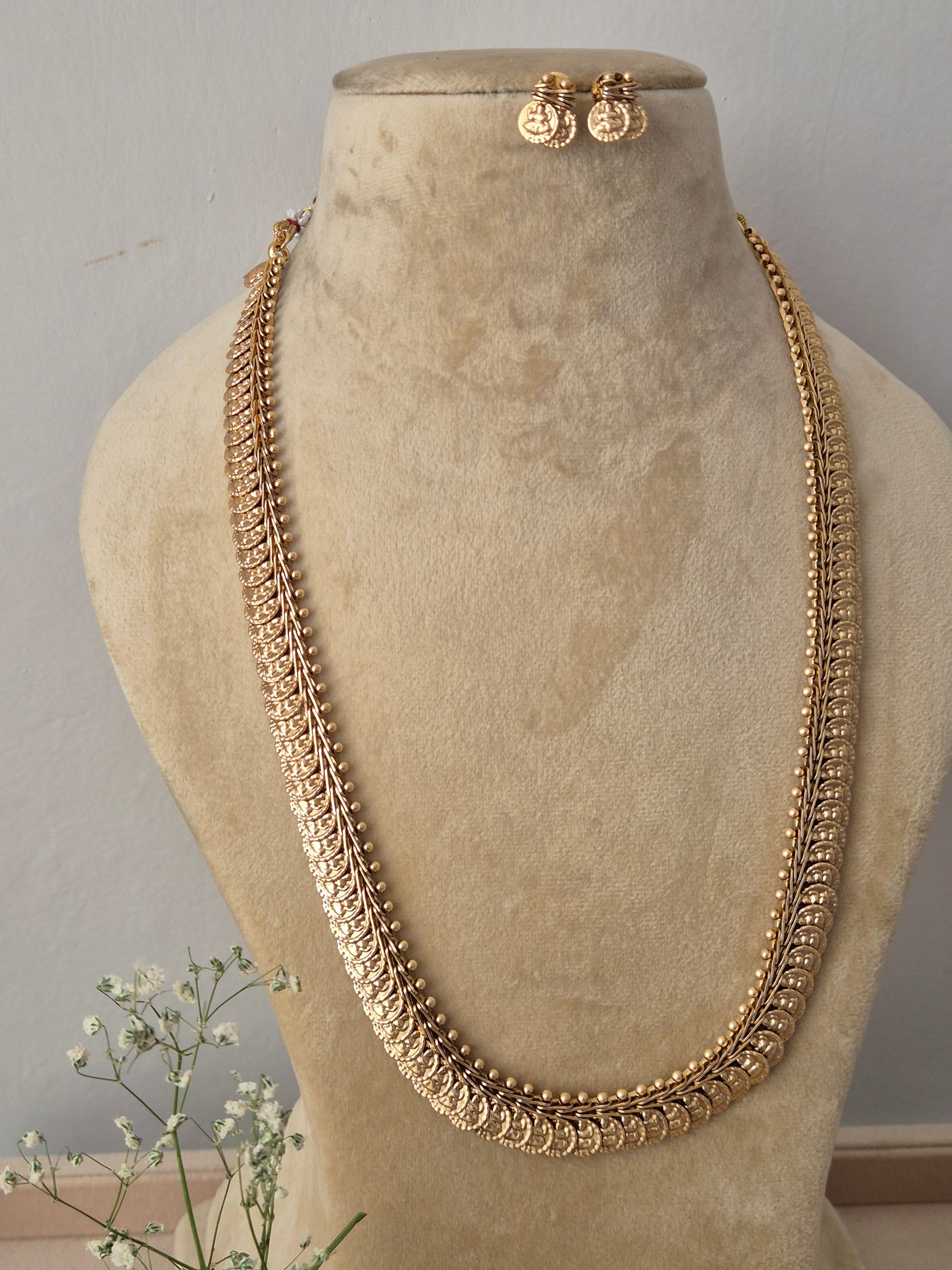 Elaborate gold-toned collar-to-chest length opera necklace featuring textured metallic bead motifs and woven patterns, shown with coordinating round earrings, Handcrafted antique gold statement jewelry set showcasing a multi-textured ethnic design, ideal for festive, traditional, or bridal wear by naitri.in