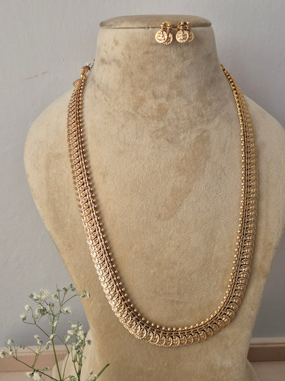 Elaborate gold-toned collar-to-chest length opera necklace featuring textured metallic bead motifs and woven patterns, shown with coordinating round earrings, Handcrafted antique gold statement jewelry set showcasing a multi-textured ethnic design, ideal for festive, traditional, or bridal wear by naitri.in