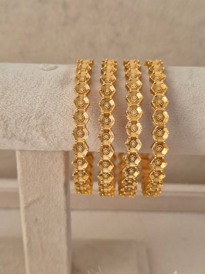 Festive Indian gold-plated bangles with fine antique finish detail for weddings and special occasions by naitri.in