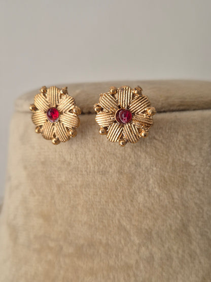 Gold-polished delicate with red stone embellishments and round Shaped earring by naitri.in