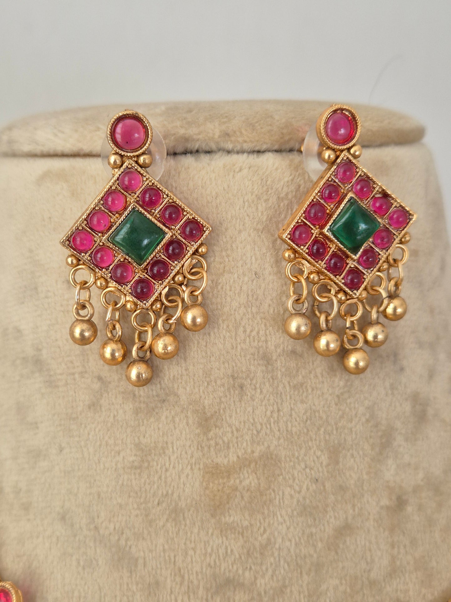 A pair of gold-plated traditional Indian chandelier earrings with pink and green stones, by naitri.in