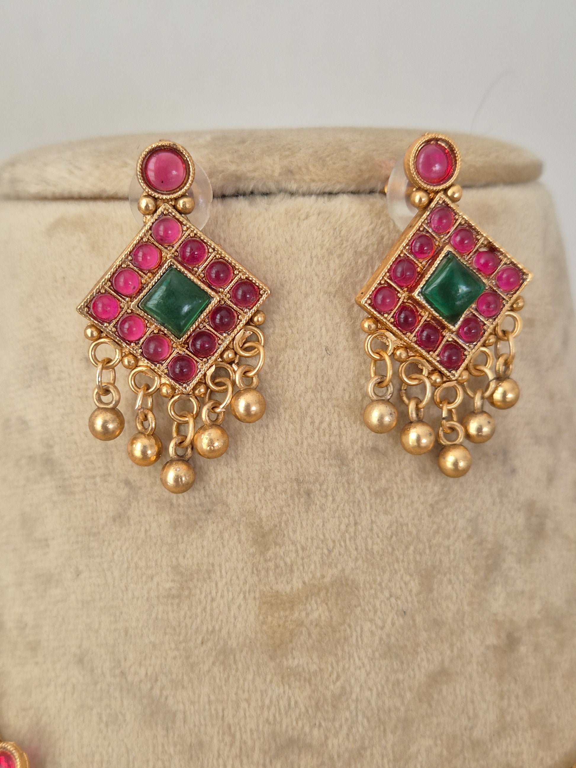 A pair of gold-plated traditional Indian chandelier earrings with pink and green stones, by naitri.in
