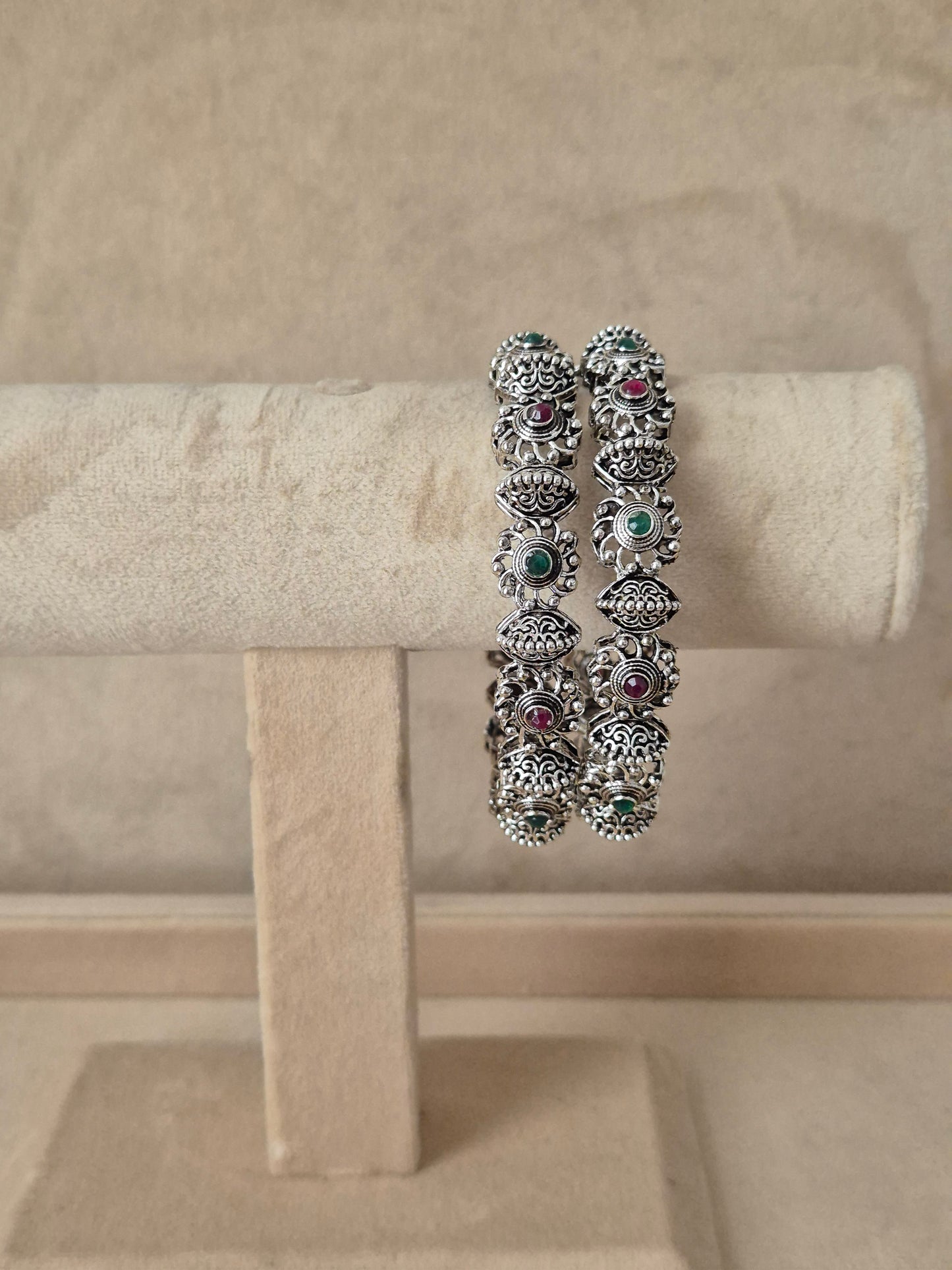 Antique silver oxidized bangle featuring an intricate center row of circular motifs flanked by textured border By naitri.in