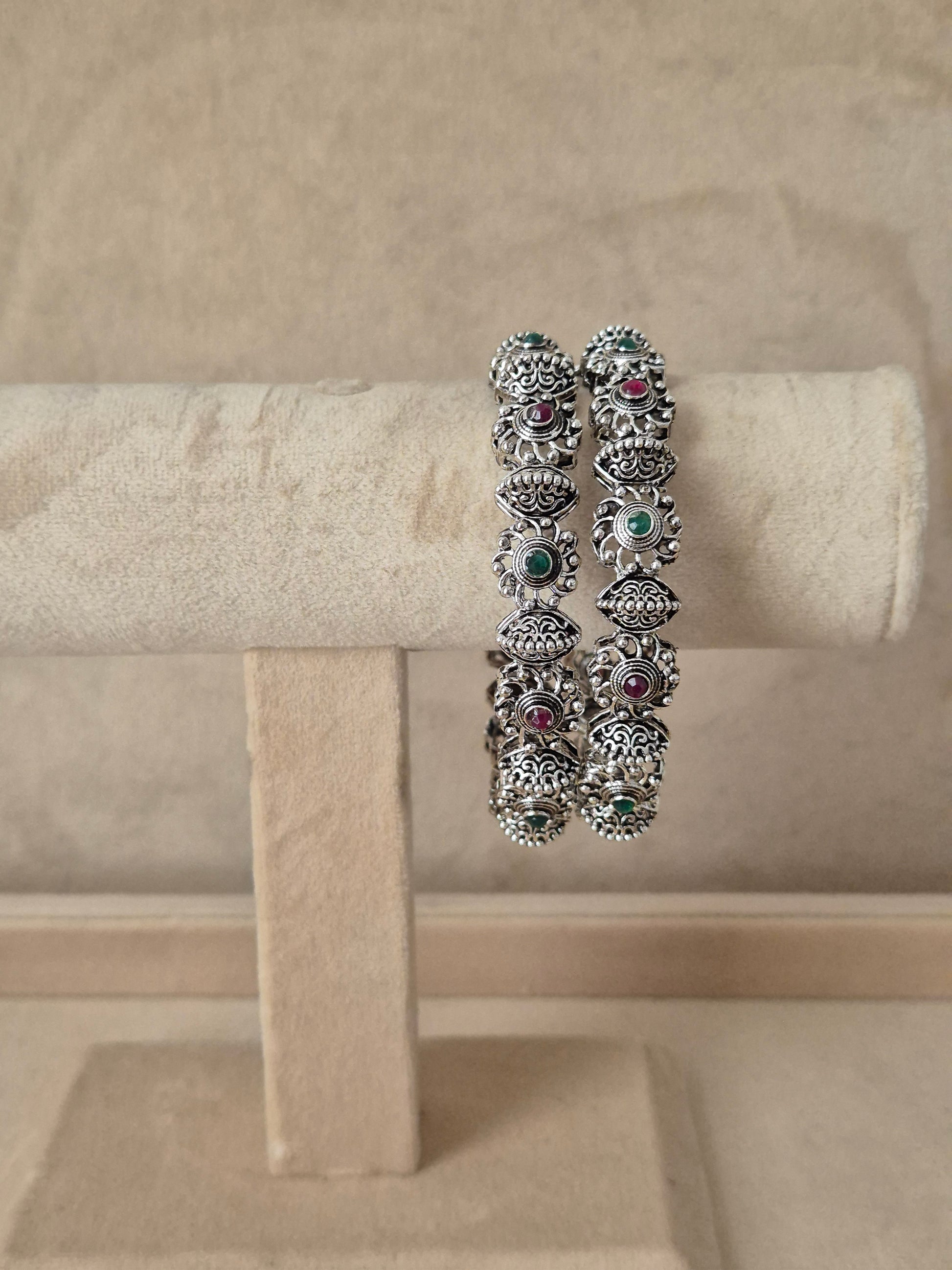 Antique silver oxidized bangle featuring an intricate center row of circular motifs flanked by textured border By naitri.in
