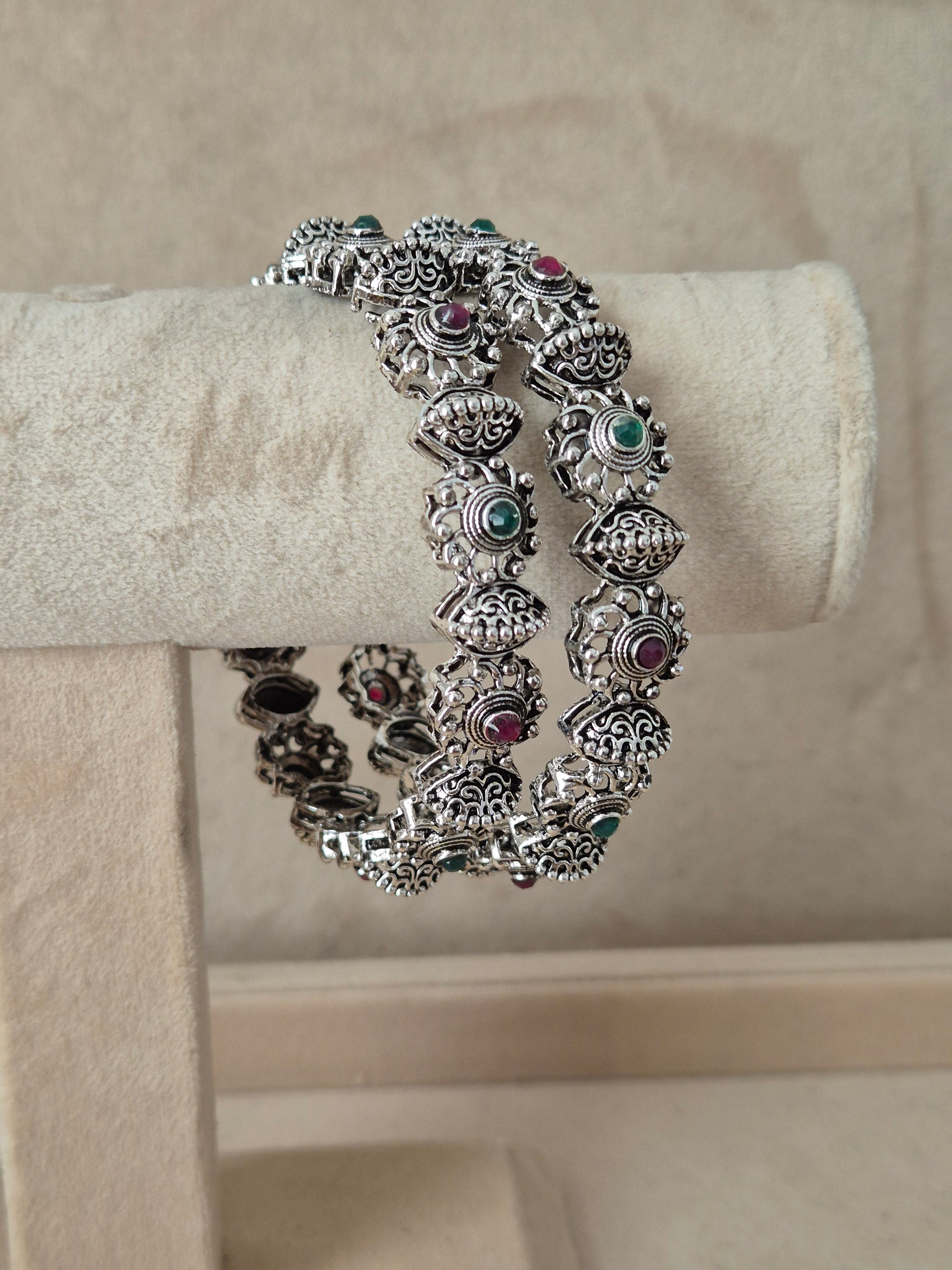 Detailed antique silver oxidized bangle with an engraved circular and geometric pattern by naitri.in
