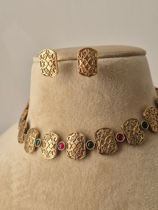 Handcrafted Diksha golden necklace set with traditional geometric patterns and multicolored stone embellishment by naitri.in