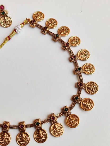 Antique gold-plated Divine Temple Jewellery Necklace Set with red and green stones.