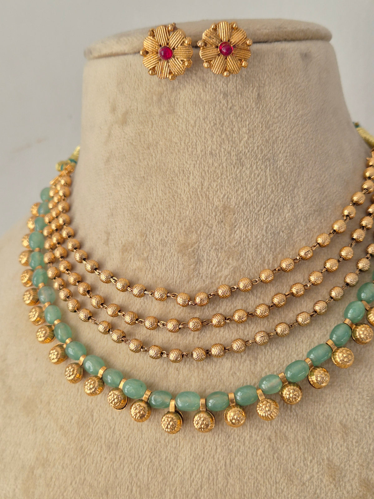Handcrafted Brass Alloy Choker with distinctive multi-strand rows of green and golden beads, offering a rich ethnic look designed for festive and traditional wear by Naitri.in