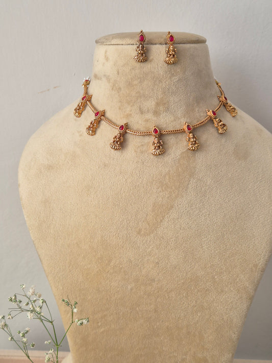 Gold choker necklace with hanging deity charms and matching earrings by naitri.in