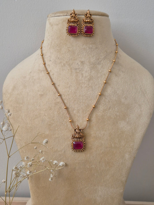 handcrafted gold-toned necklace set with vibrant ruby red square stones and geometric accents by naitri.in