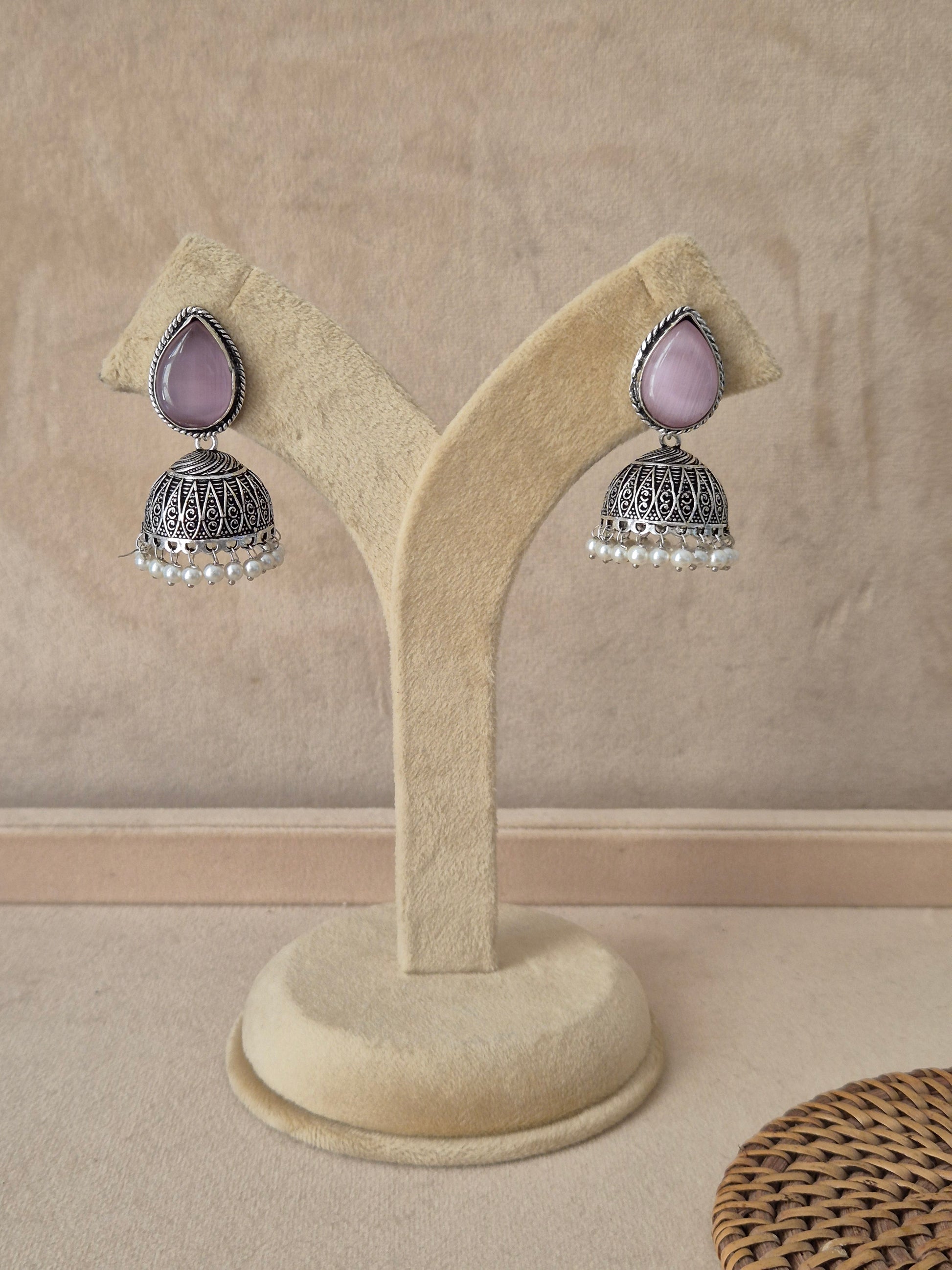 Pair of Ekta handcrafted silver-toned drop earrings with pink accents by naitri.in