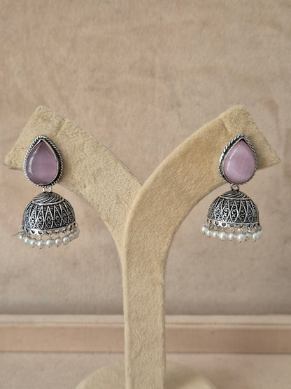 Silver imitation jewelry drop earrings featuring pink stone embellishments and Modern Indian aesthetic silver-plated geometric earrings featuring delicate pink stone details by naitri.in