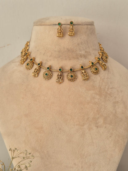 Gold-toned traditional necklace and matching drop earrings displayed by naitri.in