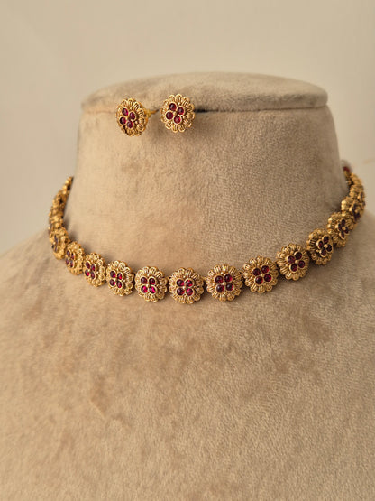 Flower shaped design necklace which have four small red stones simple and attractive with matching earrings by naitri.in
