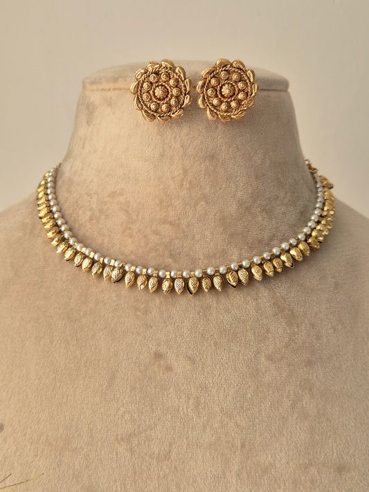 Gold necklace and earrings, earring having flora round design with small gold beads attached inside and small tear shaped design attached out side earring making petals by naitri.in