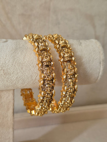 Two gold bangles, Festive style golden statement bangles by naitri.in