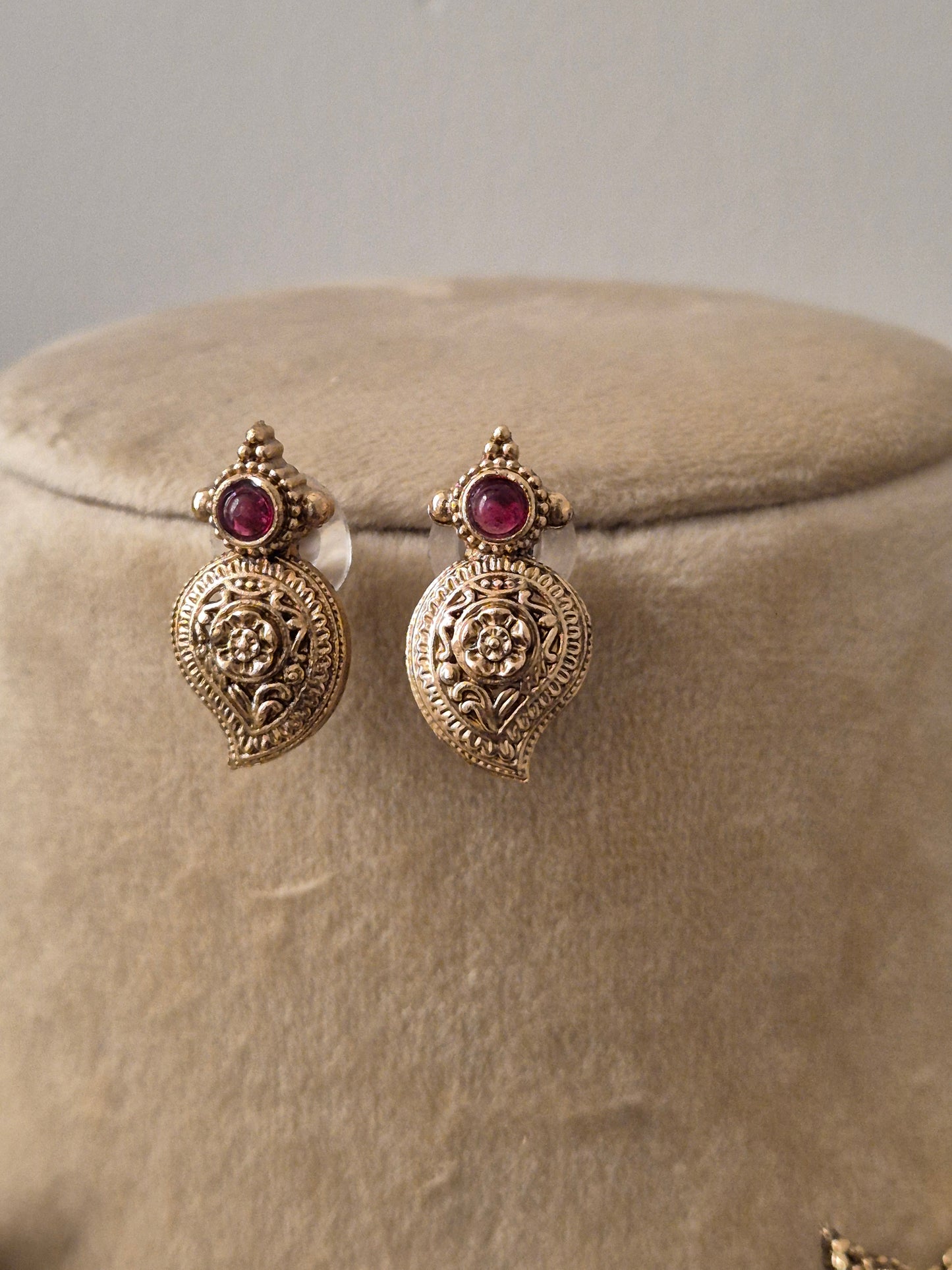 Gold-toned ethnic leaf-motif charms, ruby-red by naitri.in
