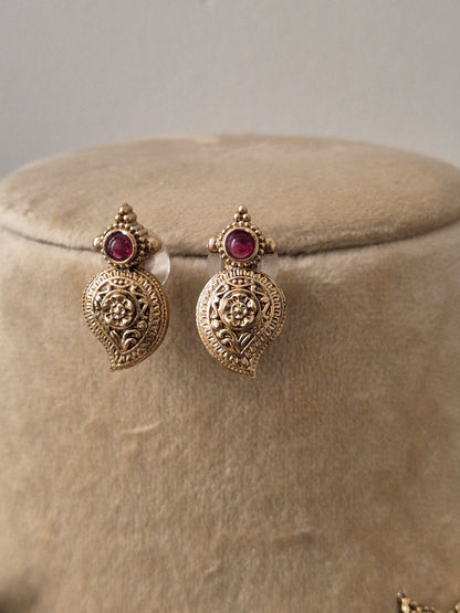 Gold-toned ethnic leaf-motif charms, ruby-red by naitri.in
