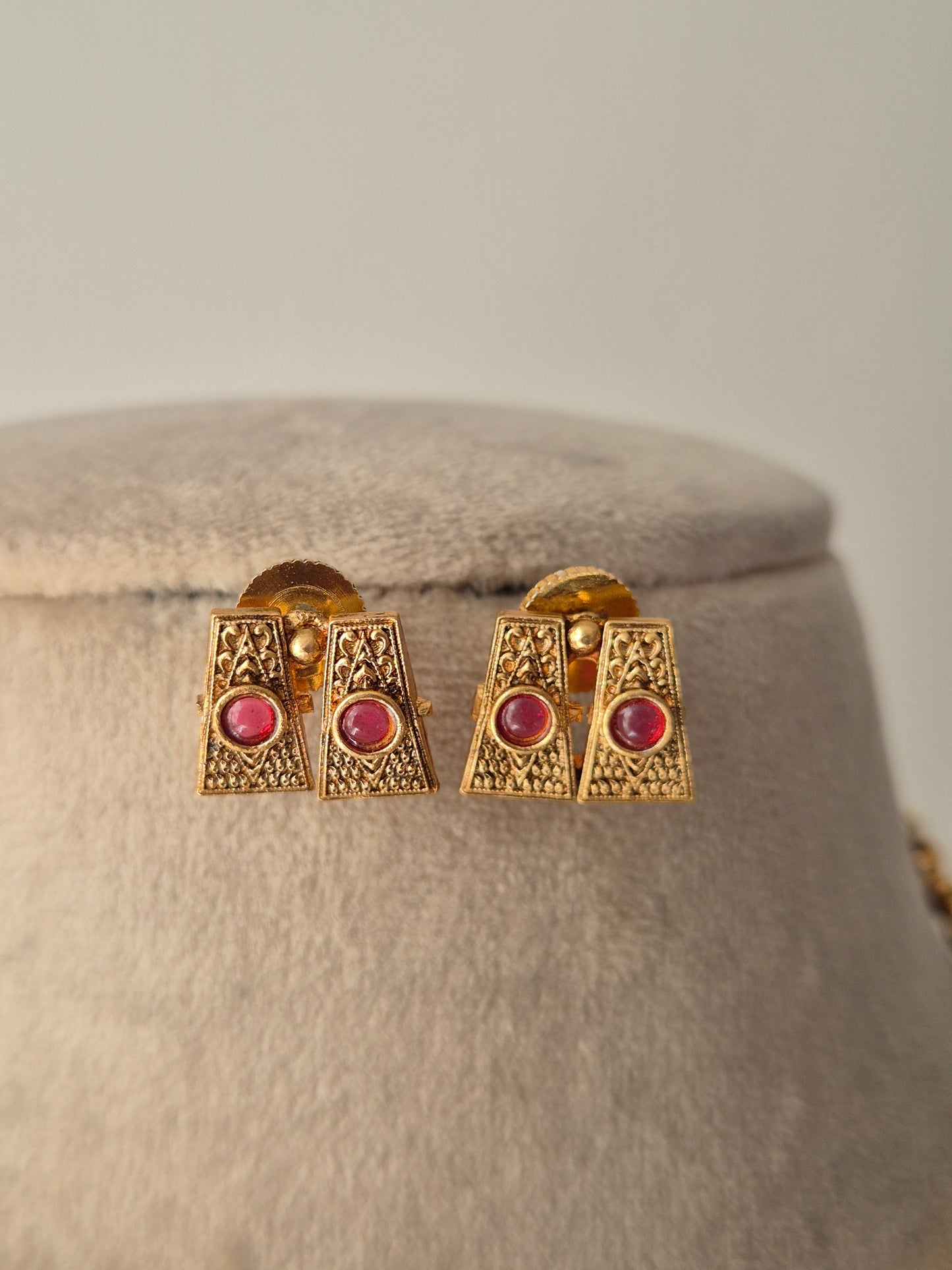 Gold earrings with red gemstones Handcrafted gold-plated brass Antique gold with ruby-colored stone accents by naitri.in