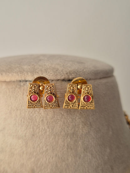 Gold earrings with red gemstones Handcrafted gold-plated brass Antique gold with ruby-colored stone accents by naitri.in
