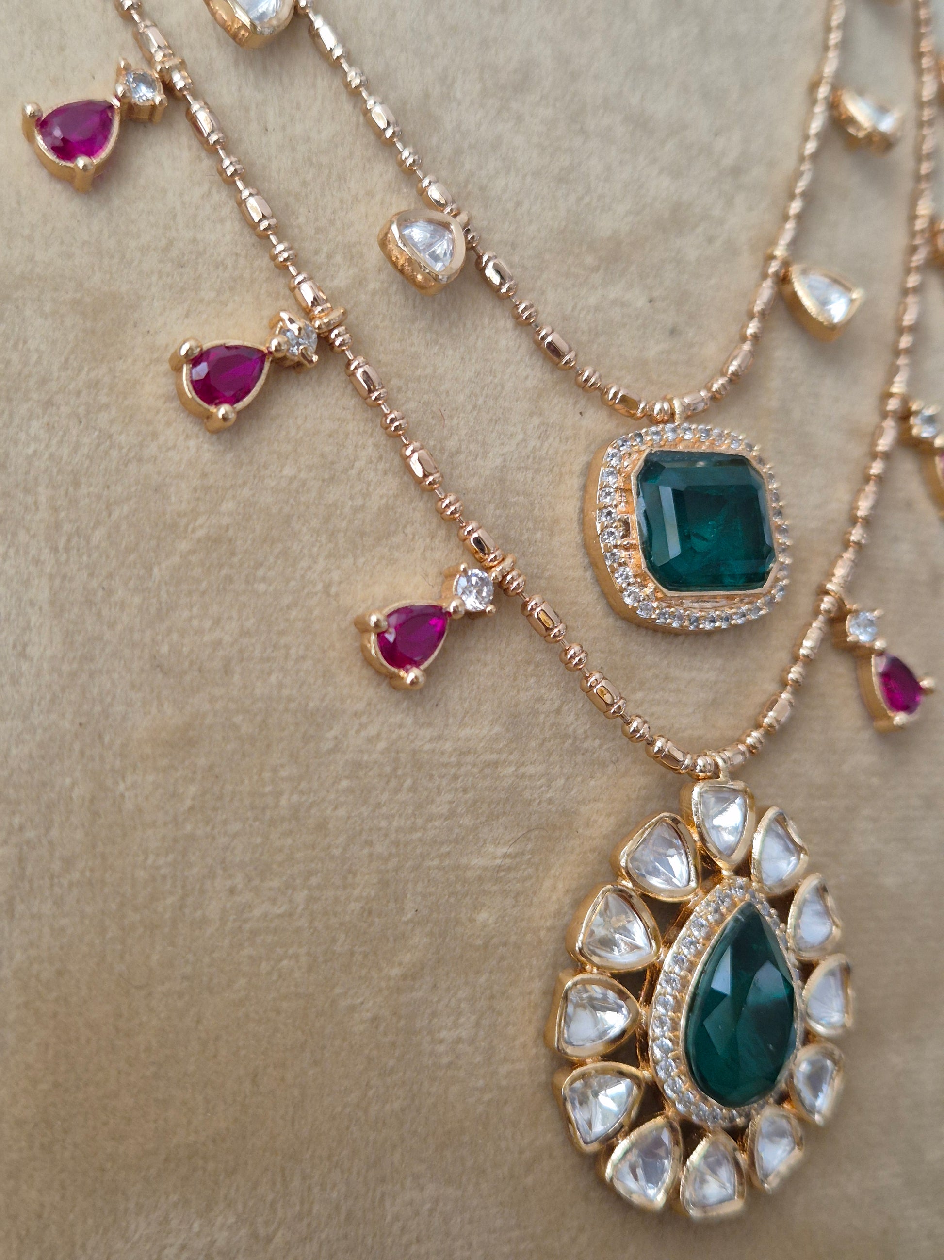Modern Indian Esme necklace set with a polished gold finish, intricate AD stonework, and colorful crystal drops, perfect for festive sarees and lehengas by naitri.in