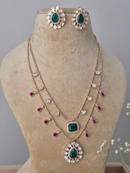 Double-layered American Diamond necklace and earring set with green and pink stone embellishments by naitri.in