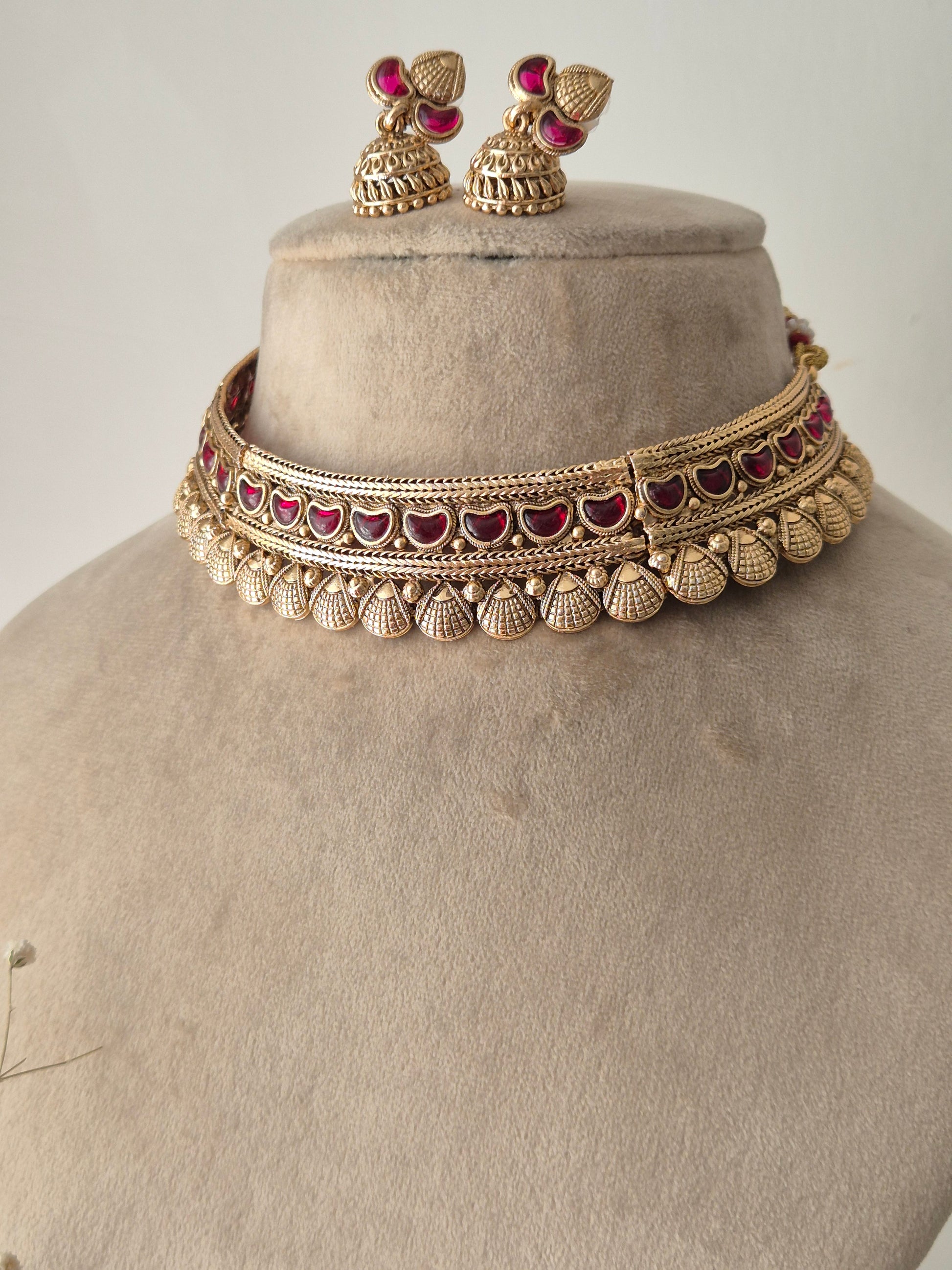 Traditional Indian Gold Jewellery Set with Red Stones and Matching Earrings by naitri.in