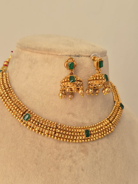 Traditional elegant necklace set with green stones withasame designed  Jhumki available at naitri.in